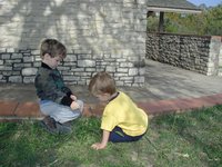 2001-10-26-Camping-McKinney-Falls-25-Chance-Aaron-blowing-dandylion.JPG