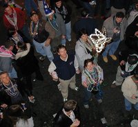 2002-02-07-Mardi-Gras-Balcony-3-beads-midair.JPG