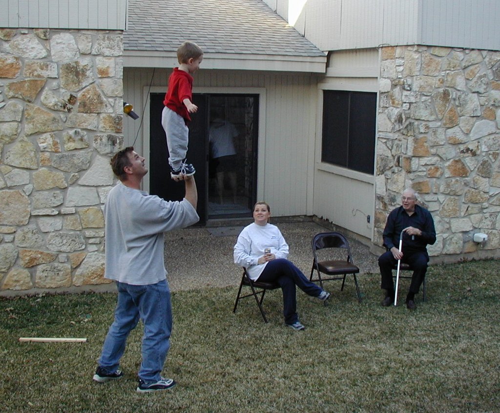 2002/02(February)/Melvin-Mary-Visit/1024x768_2002-02-25-20-Chance-Justin-stunting-Katie-Justin.JPG