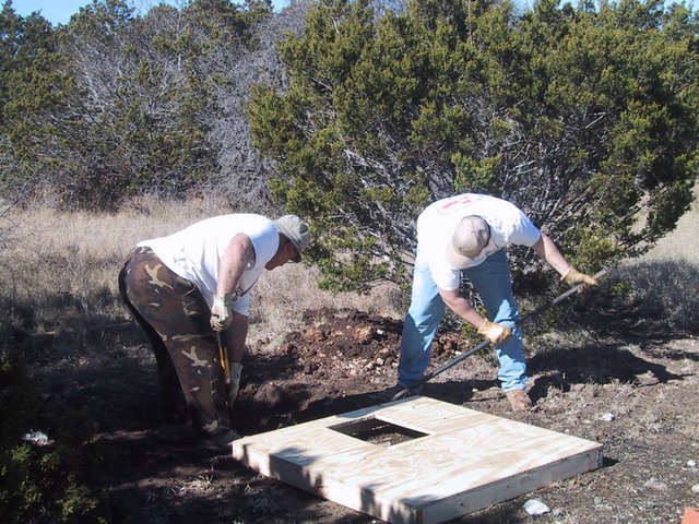 2002-12-12-Texas-Hunting-13-Val-Steve-outhouse-hole.jpg