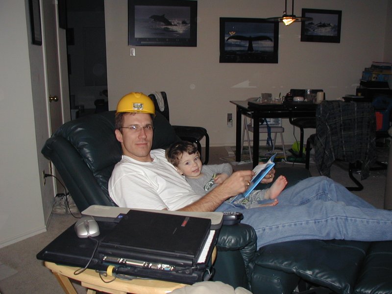 2003-02-09-Travis-reading-to-Dax-hardhat.JPG