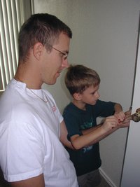2004-07-18-Chance-Helping-Travis-fix-doorknob-2.JPG