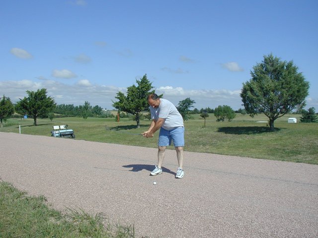 2004-07-30-Fish-Lake-Golf-09-John-on-dirt-road.JPG