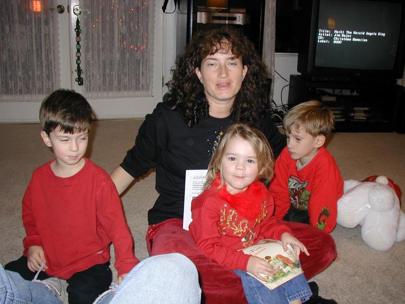 2004-12-24-Christmas-Eve-05-Suzi-reading-to-Kyla-Chance-Dax.JPG