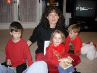 2004-12-24-Christmas-Eve-05-Suzi-reading-to-Kyla-Chance-Dax.JPG