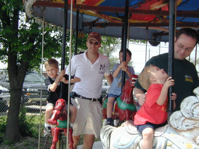 2005-04-16-Zachary-bday-Kiddie-Acres-11-Travis-Chance-Dax-merry-go-round.JPG
