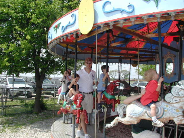2005-04-16-Zachary-bday-Kiddie-Acres-13-Travis-Chance-Dax-merry-go-round.JPG
