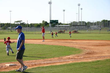 2006-05-11-Tball-124-Travis-Nick-throw-it-in.JPG