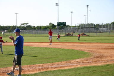 2006-05-11-Tball-126-Travis-Nick-throw-it-in.JPG