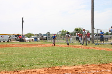 2006-06-17-Tball-AllStars-Bulldogs-Hays-CO-062-Logan-skips-to-1st.JPG