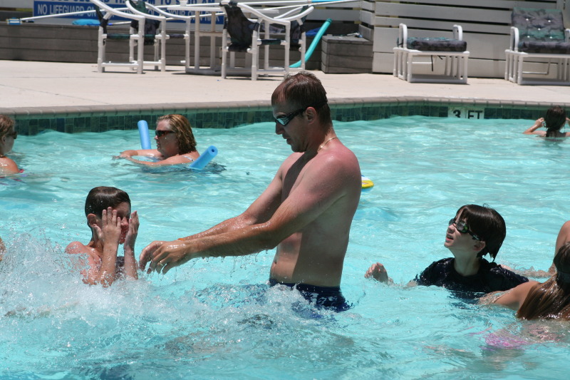 2010-07-05-Port-Aransas-091-Travis-Chance-Dax-pool-wrestling-kids.JPG
