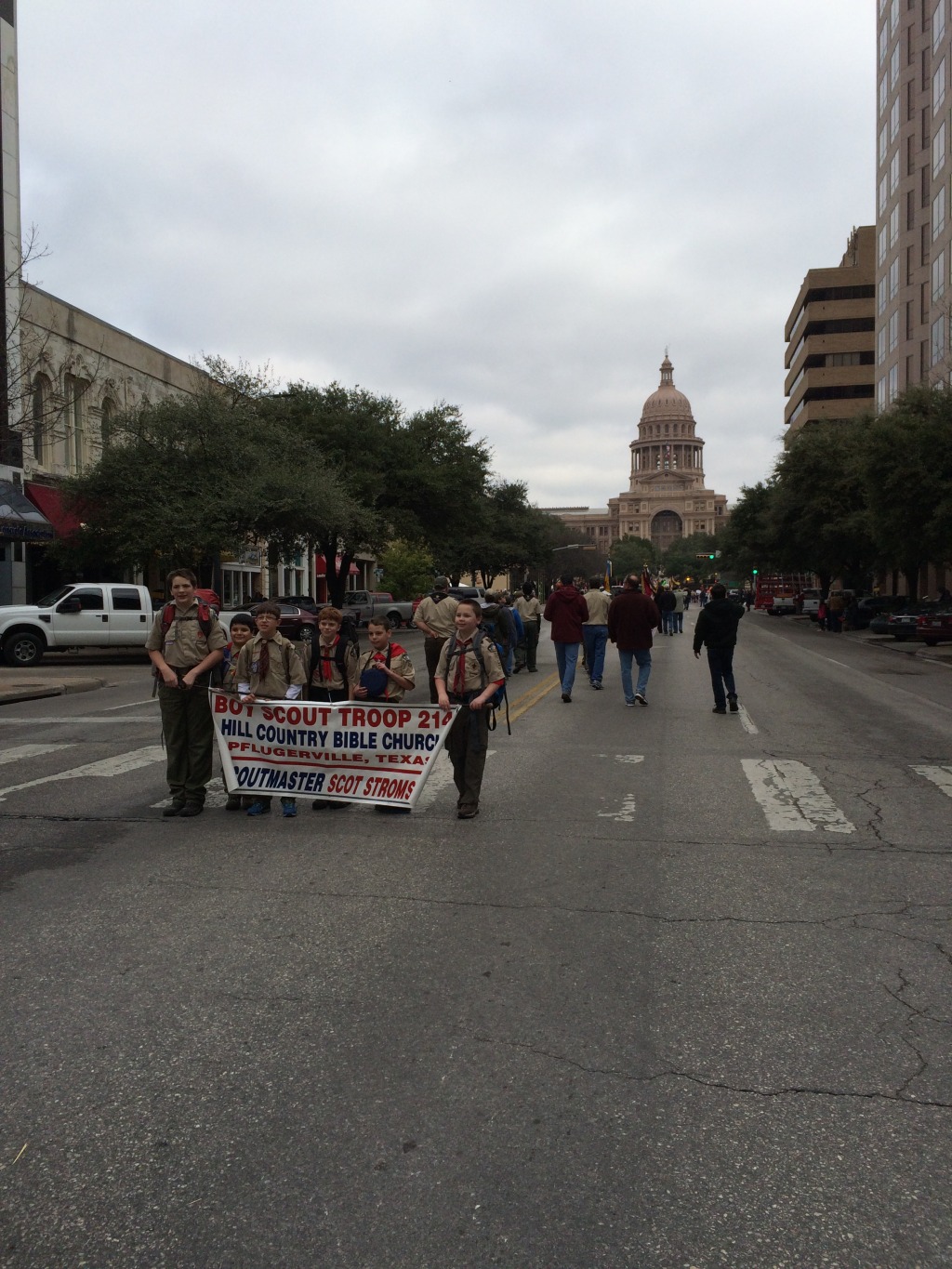 2015/02(February)/Troop214-Report-to-State/1024x768_2015-02-07-Troop214-Report-to-State-Parade-19-Case-ConnorH-ConnorM-Aiden-Zach.JPG
