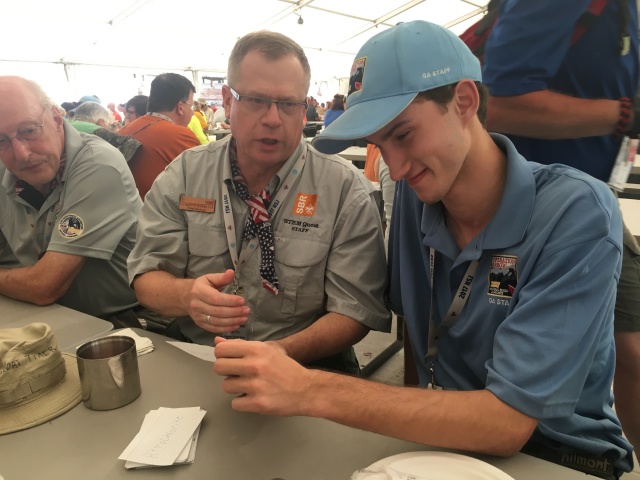 2017/07(July)/National-Jamboree/640x480_2017-07-20-National-Jamboree-08-Ken-Peter-teaching-Chemistry-to-Chance.JPG