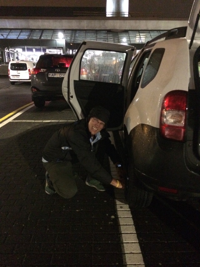2017-08-25-Iceland-04-Travis-changing-tire-at-airport.JPG