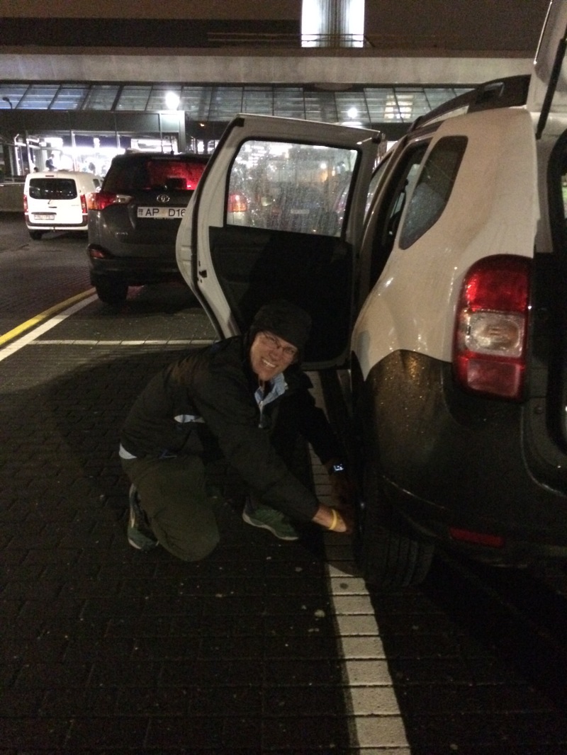 2017-08-25-Iceland-04-Travis-changing-tire-at-airport.JPG
