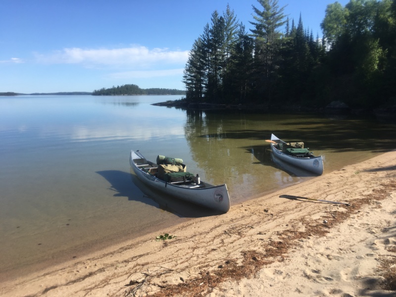 2018-06-14-Northern-Tier-Crew8787-24-canoes-on-a-calm-lake.JPG
