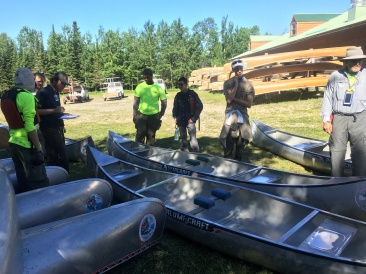2018-06-13-Northern-Tier-Crew8787-01-Dax-Eric-Phillip-Chance-Carl-picking-canoes.JPG