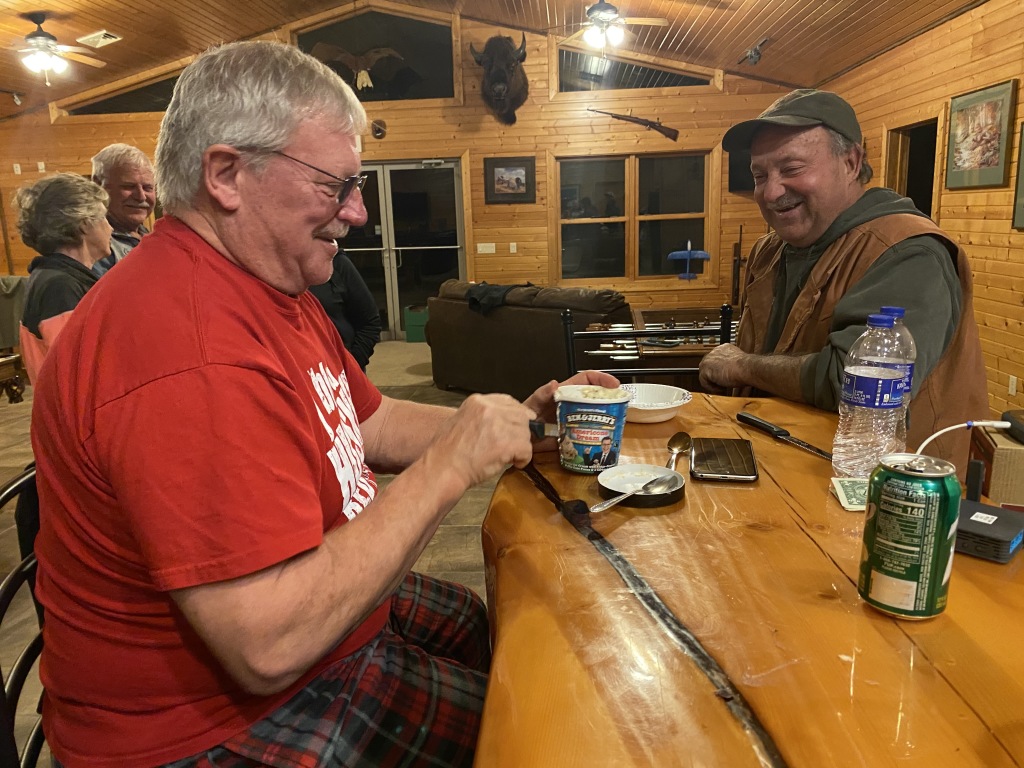 2020/11(November)/Hunting-South-Dakota/1024x768_2020-11-13-SD-Hunting-13-Janeen-Jim-John-cutting-ice-cream-in-half.JPG