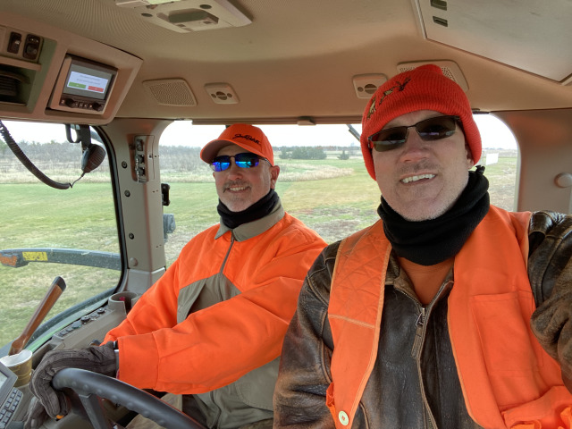 2021-11-11-South-Dakota-Hunting-04-Mike-Travis-driving-Tractor.jpg