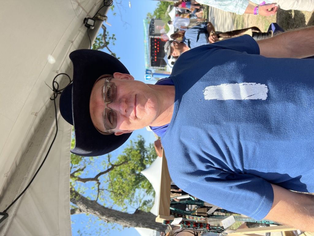 2023/04(April)/Two-StepInn-Festival-Georgetown-TX/2023-04-15-Two-Step-Inn-Festival-01-Travis-trying-a-hat.JPG