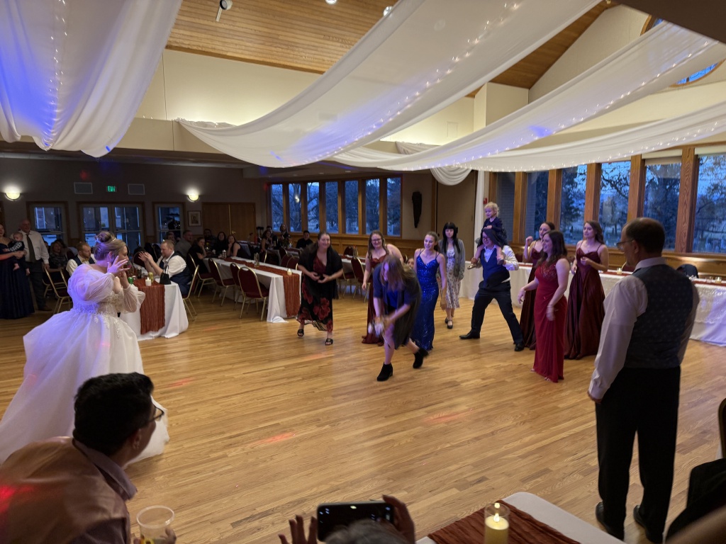 2025-11-08-McKenzie-BenBeatty-Wedding-094-boquet-toss-Zeta.JPG