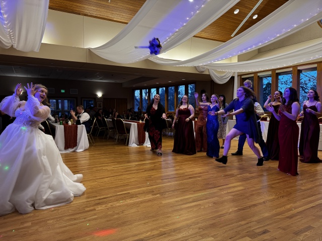 2025-11-08-McKenzie-BenBeatty-Wedding-095-boquet-toss-Zeta.JPG
