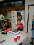 2000-12-02-Aaron-Bday-05-Kitchen-Kim-Aaron-cake.jpg
